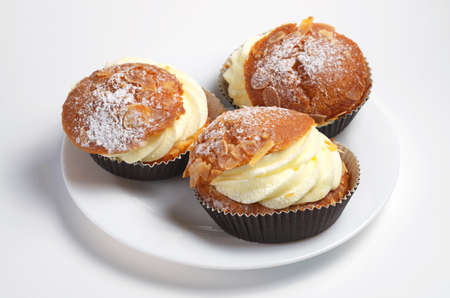 Cake with butter cream and almonds on white background
