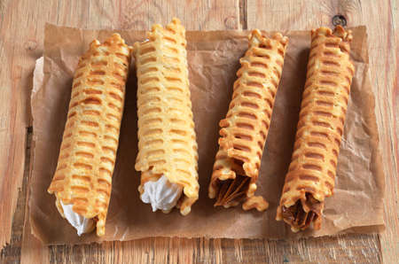 Waffle tubules with sweet creamy on rustic wooden tableの写真素材
