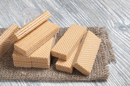 Sweet wafers on a burlap on wooden tableの写真素材