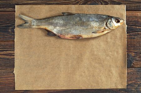 Dried salted fish for beer on paper background on table. Space for text. Top view の写真素材