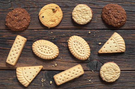 Old wooden background with various shortbread cookies, top viewの写真素材