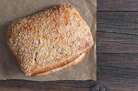 Ciabatta bread with flax seeds on dark wooden background, top viewの写真素材