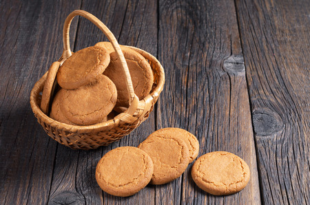 Ginger cookies in basket on dark wooden background with copy spaceの写真素材