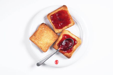 Small toast bread (roasted and with jam) in plate on white background, top viewの写真素材
