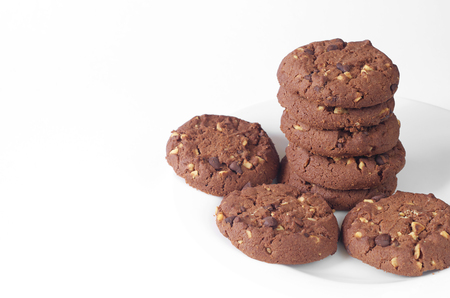 Chocolate cookie with nuts on white background closeupの写真素材