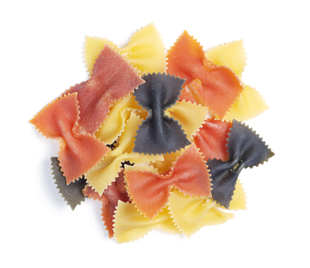 Multi colored raw pasta in the form of bows on white background close up, top viewの写真素材