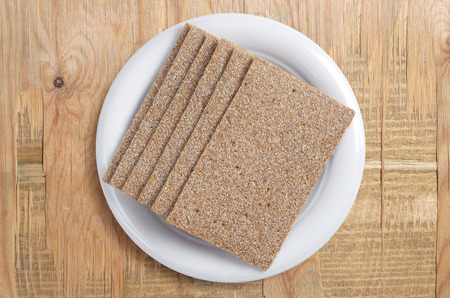 Crisp bread for diet food on a old wooden background, top view