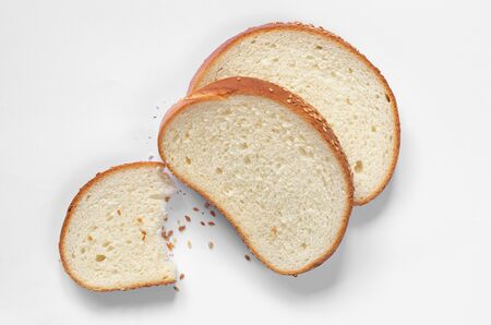 Slices of white bread with grain on white background, top view