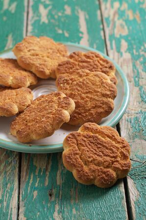 Homemade shortbread cookies on old green wooden background close-