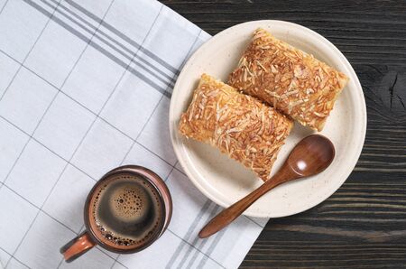 Cup of coffee and puff pastry cookies with cheese for breakfast on table, top view