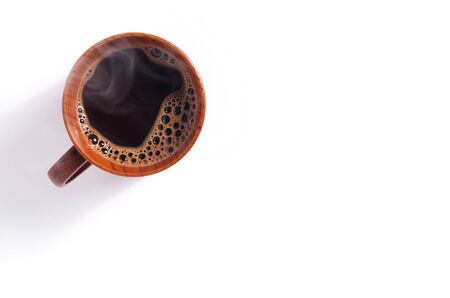Wooden cup of hot coffee on a white background, top view with copy spaceの写真素材