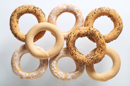 Tasty different bagels isolated on a white background, top view