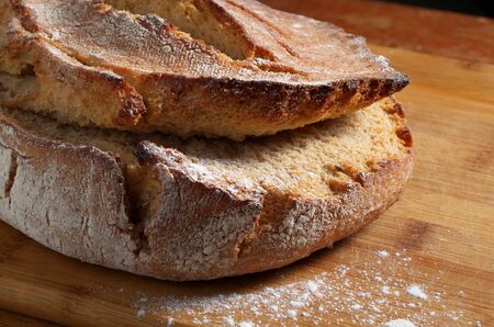 Loaf of homemade rye bread on board close-up