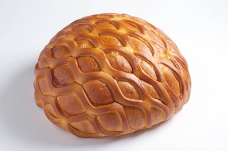 Wheat bread loaf on a white background close-up