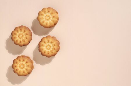Tasty shortbread cookies on light brown background, top view with copy space