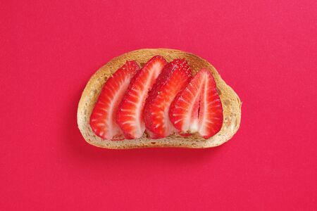 Strawberry sandwich on red background, top view