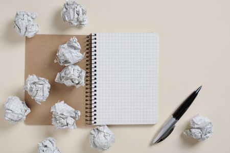 Notebook, pen and paper balls on light background, top viewの写真素材