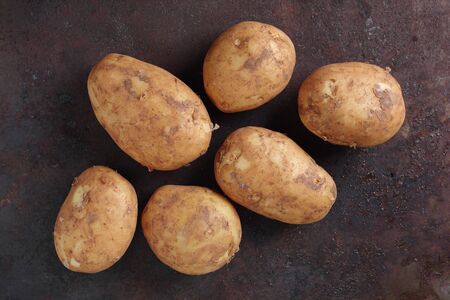 Directly above view of fresh organic potatoes on grunge metal backgroundの写真素材