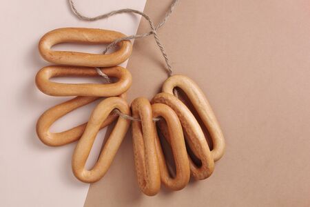 Oval bagels on a rope on a two-tone background, top viewの写真素材