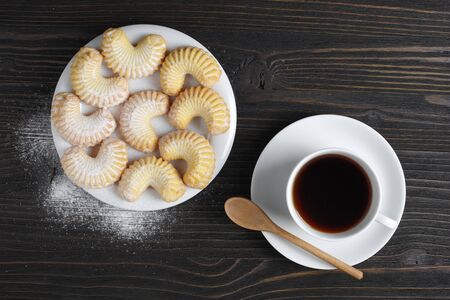 Directly above view of shortbread cookies and coffee on dark wooden table