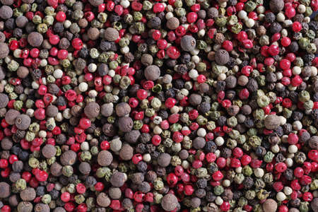Background of various colorful peppers grain, top view. Food texture