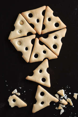 Directly above view of dry cracker cookies on old black metal tray