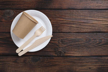 Directly above view of disposable tableware on wooden background. Copy spaceの写真素材