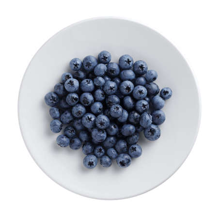 Freshly picked blueberries on a plate isolated on white background, top viewの写真素材