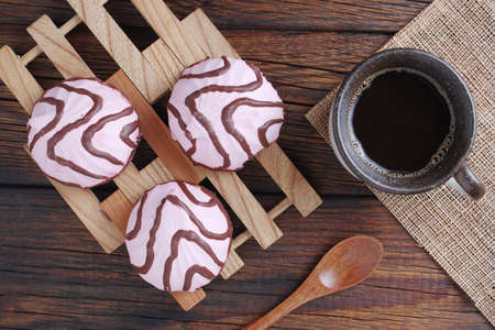 Marshmallow with chocolate and cup of coffee on wooden table, top view