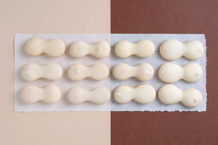 Small sugar cookies on two-tone background, top view