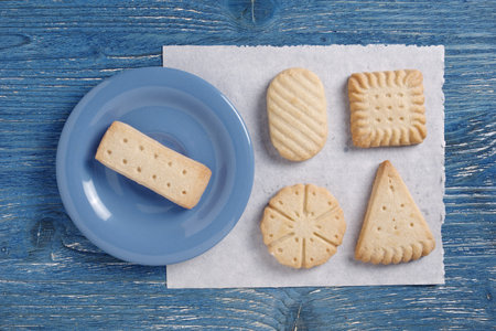 Various shortbread cookies on old blue background, top view