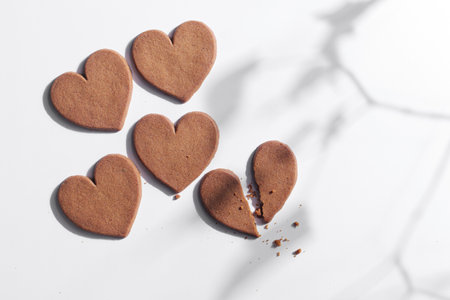 Directly above view of heart shaped ginger cookies on white background