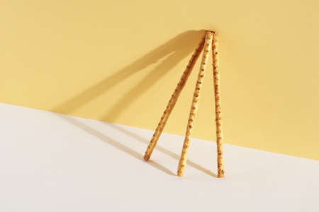 Crispy straw with seeds on white-yellow background. Space for textの写真素材