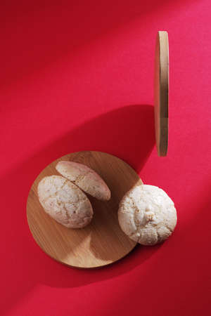 Amaretti almond cookies on red background, top view