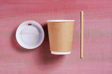 Close-up of disposable cup with lid and straw on colored background, top viewの写真素材