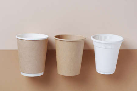 High angle view of various disposable cups for beverage located on a two-tone brown backgroundの写真素材