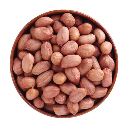 Peeled peanuts in a wooden bowl isolated on a white background, top view