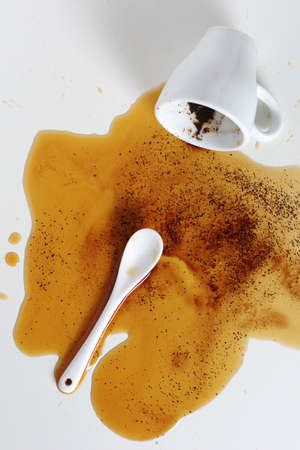 Spilled coffee cup stain on white table, top viewの写真素材