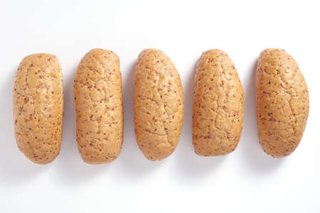 Loaves of wheat bread with grains on white background, top viewの写真素材