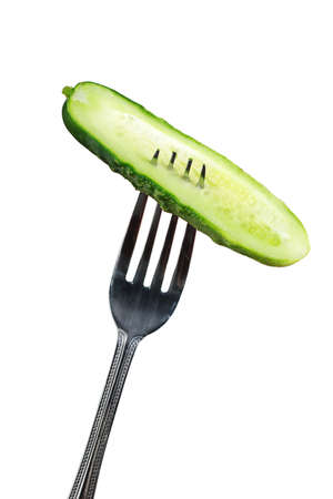 Half green cucumber on fork Isolated on white backgroundの写真素材