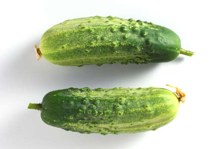 Two fresh green cucumbers on white background, top viewの写真素材