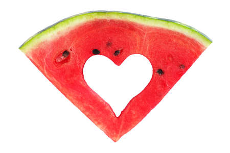 Watermelon slice with heart-shaped cut isolated on white background, top viewの写真素材
