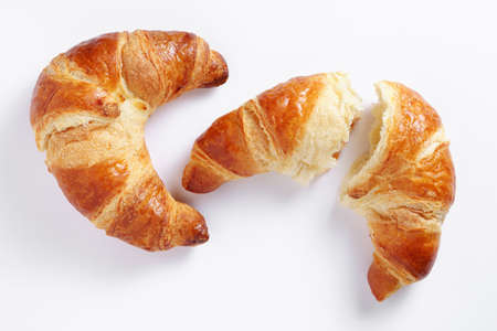 Two fresh croissants on white background, top viewの写真素材