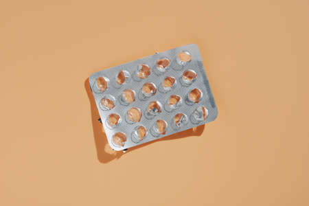Used pack of pills on yellow background, top viewの写真素材