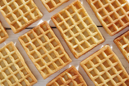 Freshly baked waffles on white table as background, top viewの写真素材