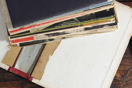 Old magazines on wooden table, top view with copy space