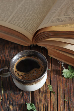 Cup of coffee and old book on the tableの写真素材