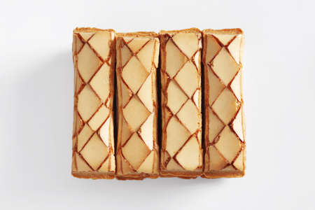 Classic puff pastries with glaze on white background, top view