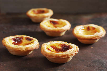 Portuguese egg tart Pastel de Nata on grunge metal background