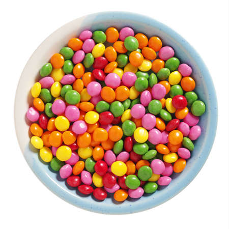 Colorful skittles candies in plate isolated on a white background, top viewの写真素材